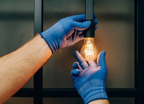 Electrician Uniform Replaces Light Bulb Handyman Professional Worker Makes Repairs — Stock Photo, Image