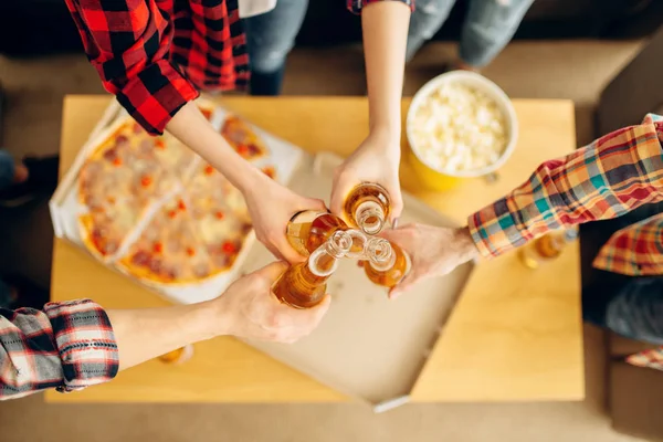 Friends Clink Bottles Beer Table Pizza Top View House Party — Stock Photo, Image