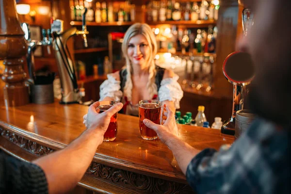 两个男性朋友在酒吧的柜台上从女服务员家拿啤酒 男人与杯子在酒吧的乐趣 酒吧女招待在传统的复古风格 — 图库照片