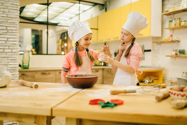 Two Little Girls Cooks Caps Tastes Sweet Vanilla Powder Cookies — Stock Photo, Image