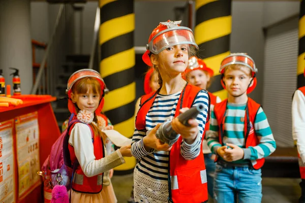 Child Helmet Uniform Hose Hands Playing Fireman Playroom Indoor Kids — Stock Photo, Image