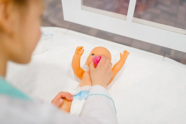 Little Girl Uniform Feeding Toy Doll Playing Doctor Playroom Kid — Stock Photo, Image