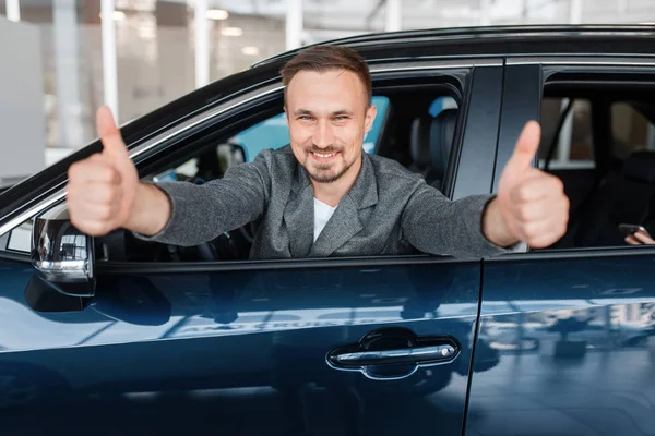 Man Sitting New Car Shows Thumbs Showroom Customer Choosing Vehicle — Stock Photo, Image