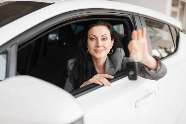 Happy Woman Shows Key New Car Showroom Female Customer Buying — Stock Photo, Image