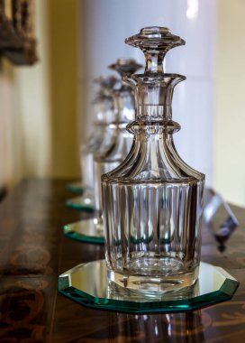 Glass decanters on the table, Europe museum, nobody. Old european architecture and style, famous places for travel and tourism clipart