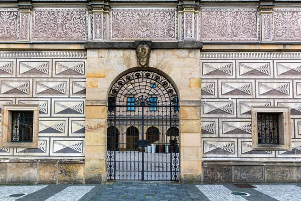 Ancient building facade with gates, old European town. Summer tourism and travels, famous europe landmark, popular places and streets