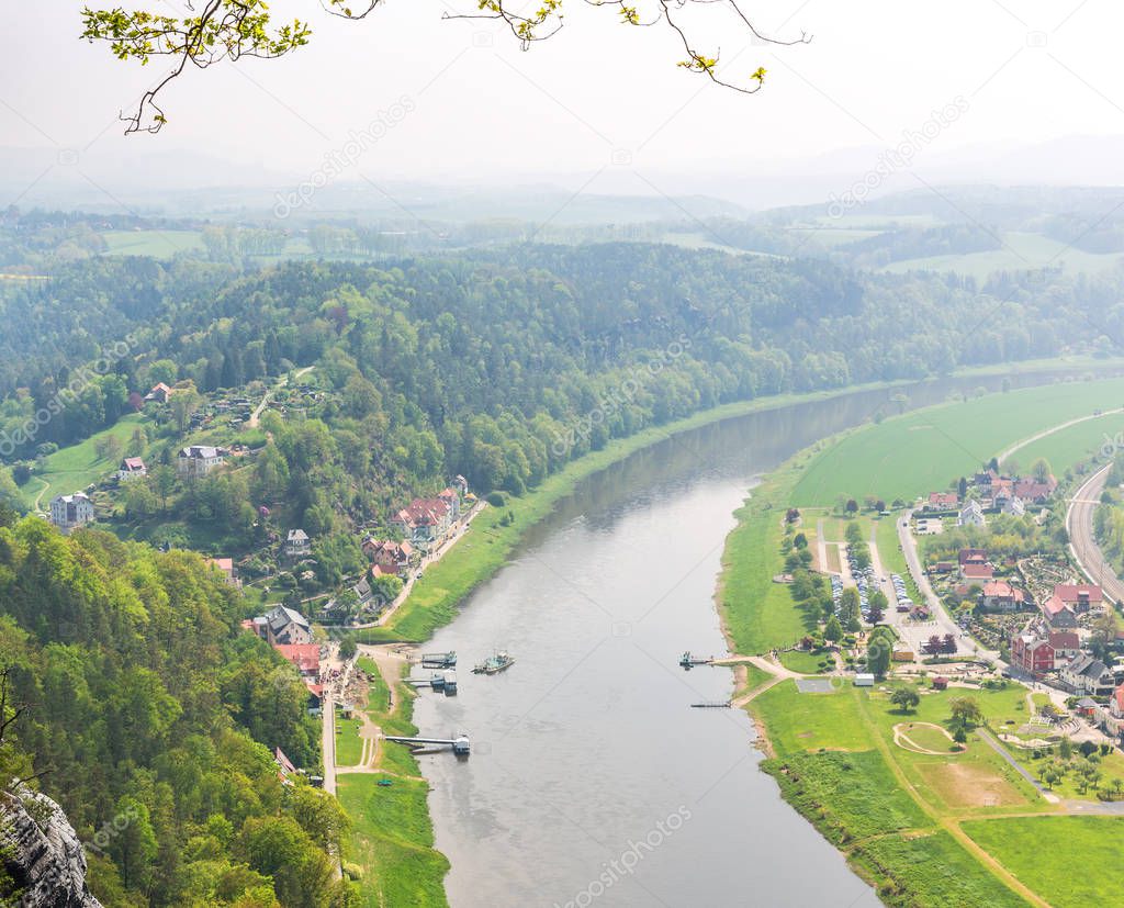 Germany, provincial town in green forest on Elbe river, view from mountain. Buildings in old european style, German landscapes