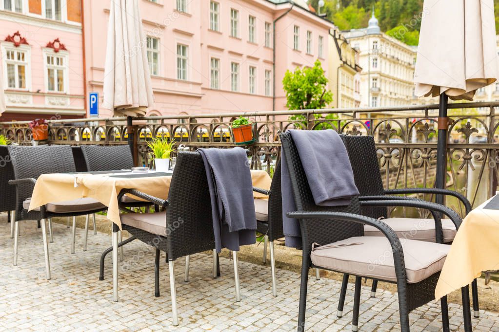 Cosy outdoor cafe with rattan furniture, Karlovy Vary, Czech Republic, Europe. Old european town, famous place for travel