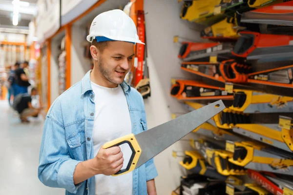 Male Customer White Helmet Choosing Saw Hardware Store Buyer Look — Stock Photo, Image