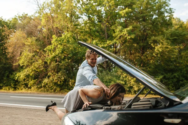 Young couple quarrel on road, car breakdown. Broken automobile or emergency accident with vehicle, trouble with engine on highway