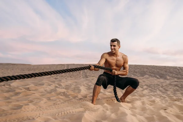 Atleta Masculino Fazendo Exercício Com Cordas Batalha Deserto Dia Ensolarado — Fotografia de Stock