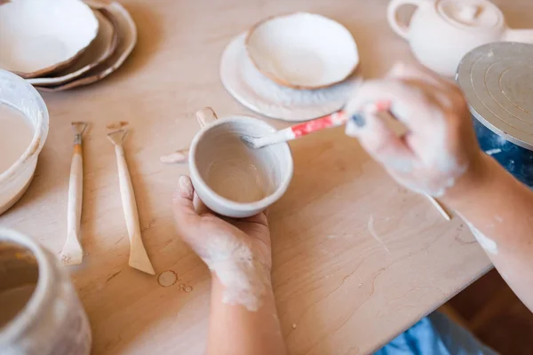 女陶工用刷子画壶 陶器作坊 一个女人在做碗 手工陶瓷艺术 陶制餐具 — 图库照片