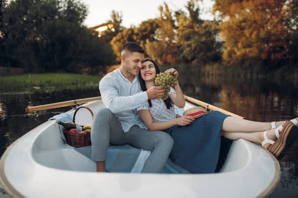情侣们在平静的湖上拥抱在一条船上 浪漫的相遇 划船旅行 男人和女人沿着河边散步 — 图库照片