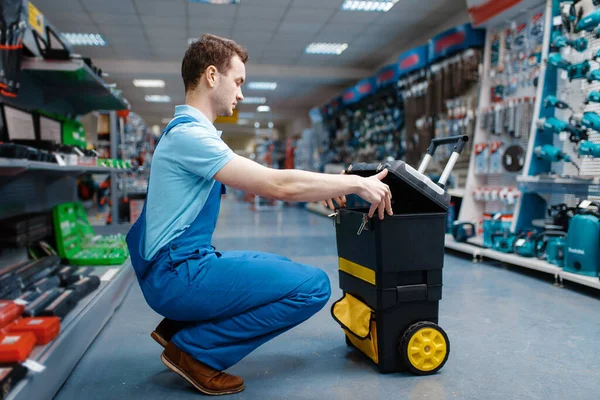 Male Worker Uniform Holds Toolbox Wheels Tool Store Choice Professional — Stock Photo, Image