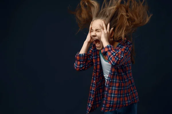 小さな女の子はスタジオで悲鳴を上げ 髪の効果を開発します 子供と風暗い背景に隔離された子供の感情 — ストック写真
