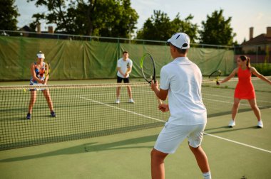 Mixed doubles tennis training, outdoor court. Active healthy lifestyle, people play sport game with racket and ball, fitness workout with racquets clipart