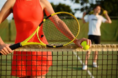 Male and female tennis players with rackets, training on outdoor court. Active healthy lifestyle, people play sport game, fitness workout with racquets clipart