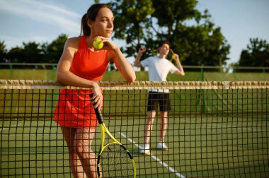 Male and female tennis players with rackets, training on outdoor court. Active healthy lifestyle, people play sport game, fitness workout with racquets clipart