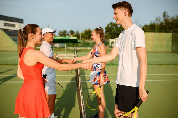 Mixed doubles tennis tournament, outdoor court. Active healthy lifestyle, people play sport game with racket and ball, fitness workout with racquets