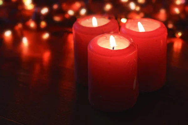 Red Candles Burning Christmas Blur Lights Background — Stock Photo, Image