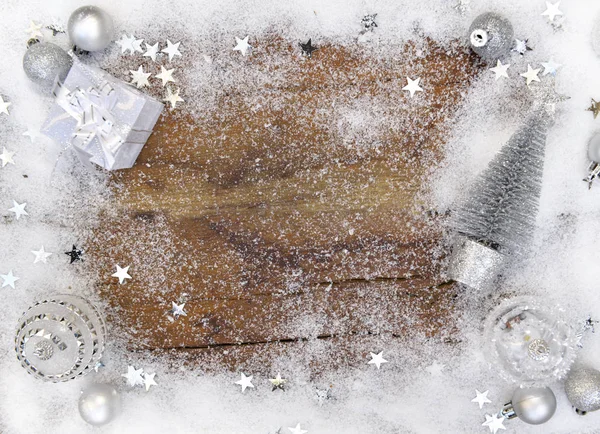 Christmas ornament in snow around a plank with empty space in the middle — Stock Photo, Image
