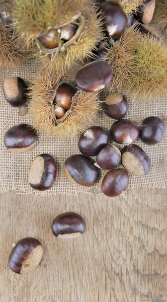 Vista dall'alto su castagne dolci fresche e granate su una tavola — Foto Stock