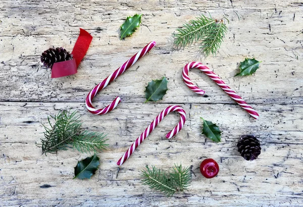 Top view on candy canes and christmas decoration on rustic woode — Stock Photo, Image