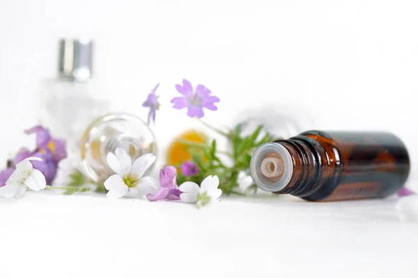 Close Spilled Bottle Essential Oil White Table Petals Flowers — Stock Photo, Image
