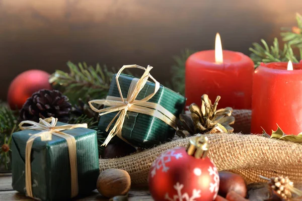 ろうそくやギフトで木製の背景に伝統的なクリスマスの装飾 — ストック写真