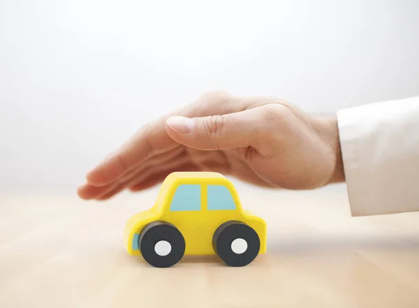 Car Insurance Concept Small Toy Car Covered Hand — Stock Photo, Image