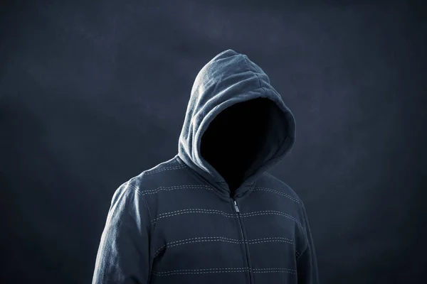 Hooded man in the dark