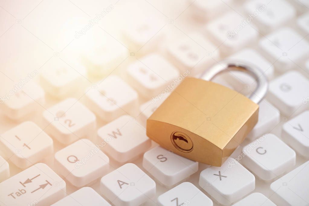 Security concept with metal padlock on computer keyboard 