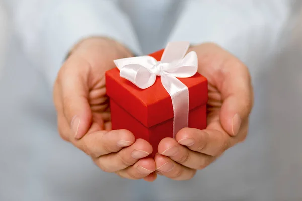 stock image Small red present box in hands 