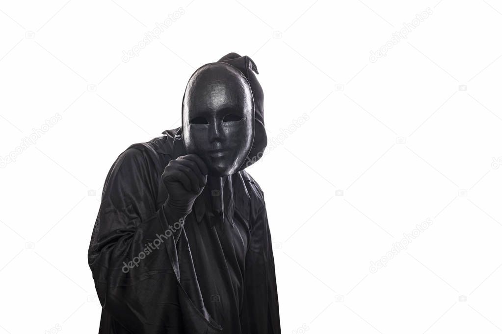 Scary figure in hooded cloak with mask in hand isolated on white background 