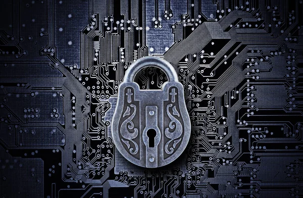 Computer security concept. Old mysterious padlock on computer circuit board