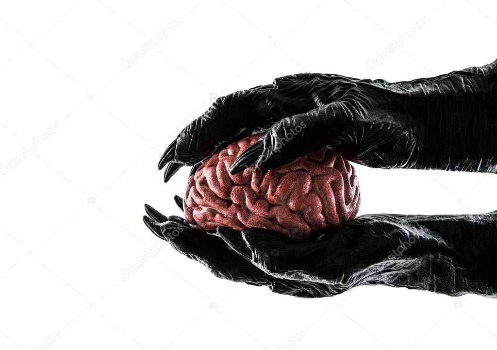 Human brain in monster hands isolated on white background with clipping path. Free your mind concept