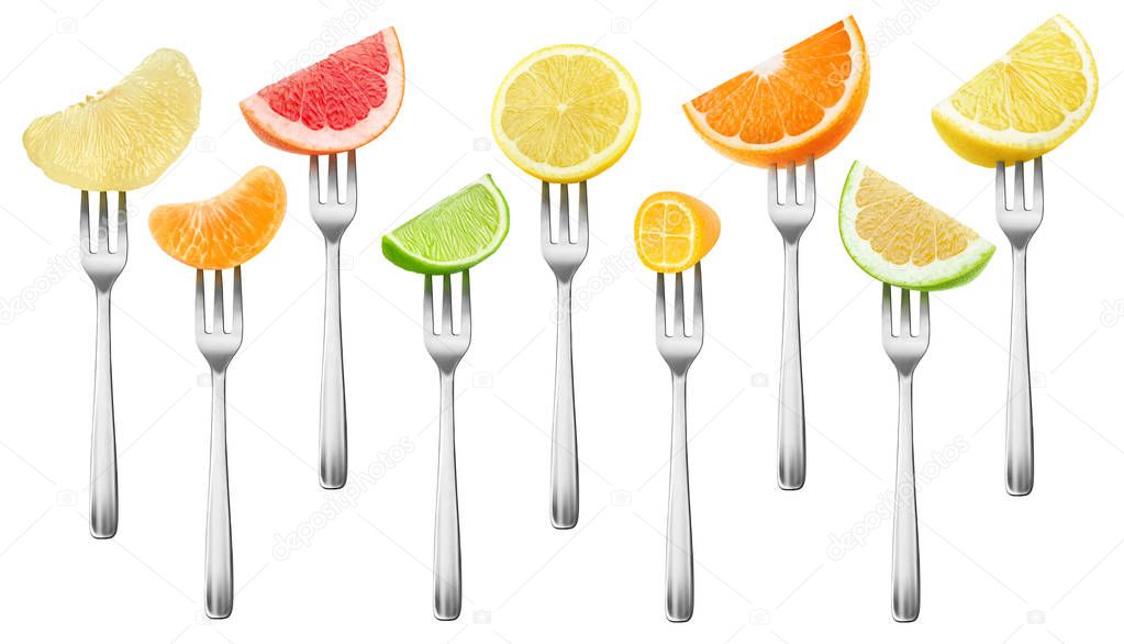 Isolated citrus pieces collection. Grapefruit, lemon, orange, lime and kumquat fruits on a dessert forks isolated on white background with clipping path