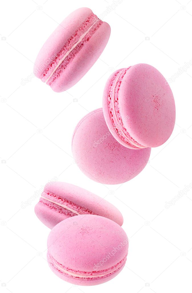 Five falling pink macaroons isolated on white background