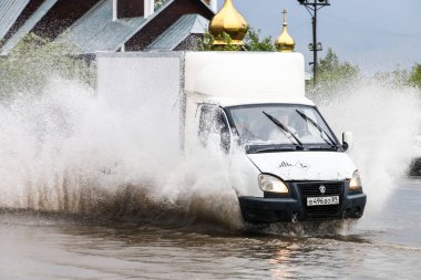 Novyy Urengoy, Russia - August 14, 2018: Motor car GAZ 3302 Gazelle in the city street during a heavy flood.