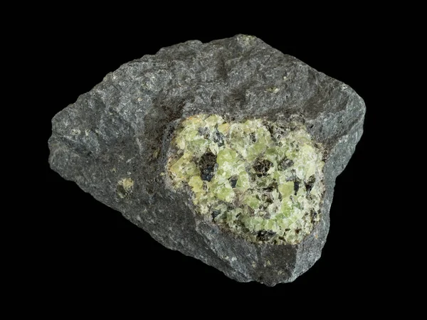 Green peridote (olivine) in dark basalt rock — Stock Photo, Image