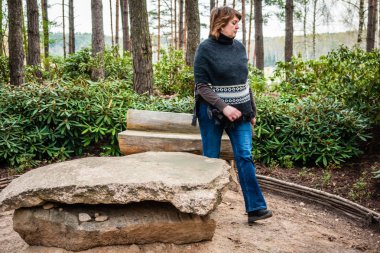 Orta yaşlı kadın bir ponch Park'ta dinlenme