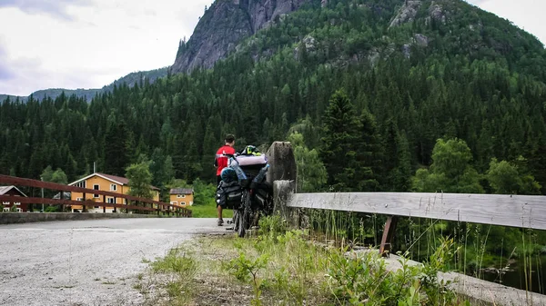 Cyclists traveling in the mountains of Norway.