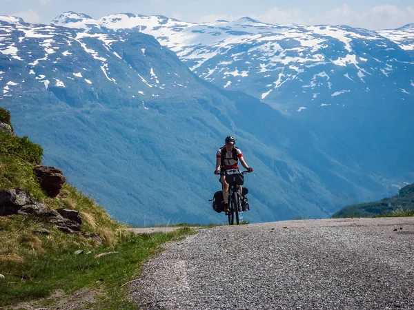 Cyclists traveling in the mountains of Norway.