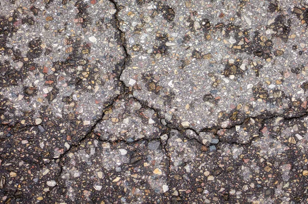 Textura de asfalto velho em rachaduras — Fotografia de Stock