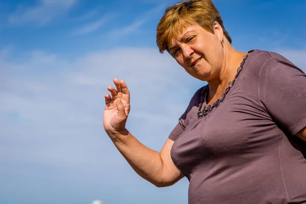 Rijpe vrouw rustend op de zee — Stockfoto