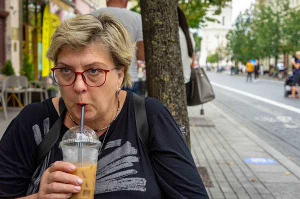 Sorgsen Kvinna Med Glasögon Går Genom Gatorna Gamla Stan Dricker — Stockfoto