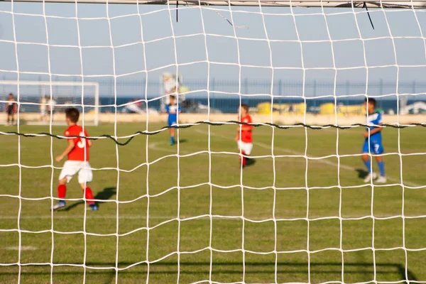 Young football players on the field near the Black Sea