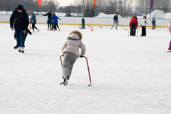 Ice skating with child support device — Stock Photo, Image