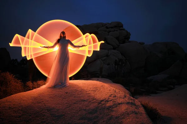 Persona luce dipinta nel deserto sotto il cielo notturno — Foto Stock