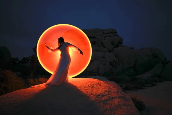 Lumière de la personne peinte dans le désert sous le ciel nocturne — Photo